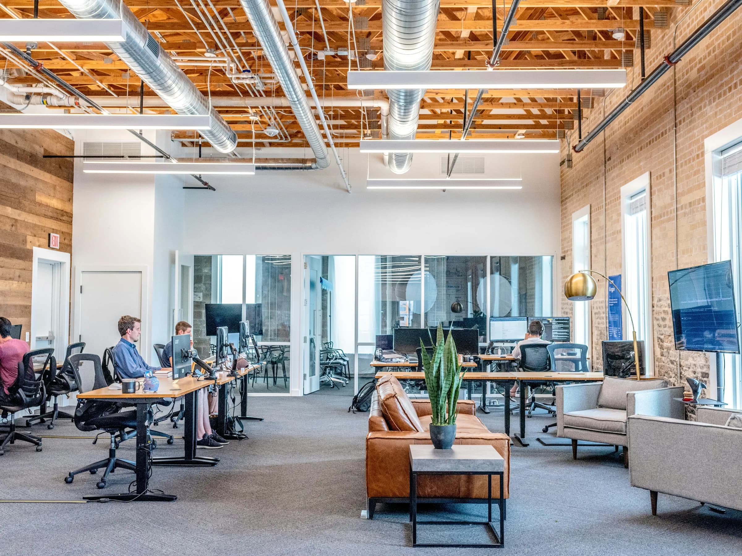 Modern commercial office interior with exposed services and lighting