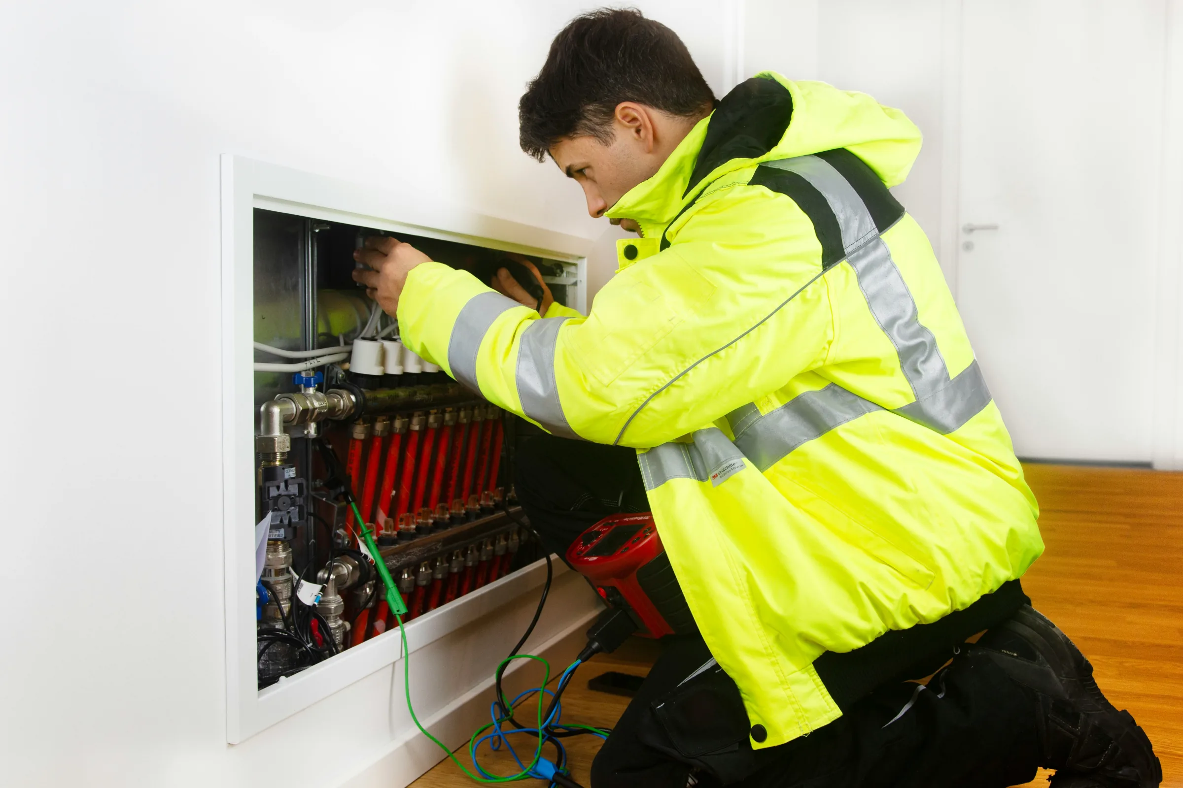 Temporary illustrative image of an electrician working inside a residential electrical cabinet